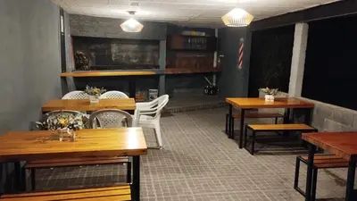 a dining room with wooden tables and white chairs at Los Ceibos dpto para 4 personas in Estancia Vieja