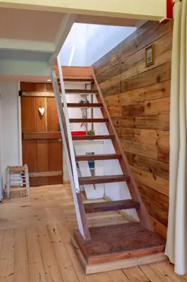 a staircase in a room with a wooden wall at Las Martinetas in Santa Rosa de Calamuchita