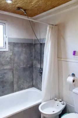a bathroom with a shower and a toilet and a sink at Las Martinetas in Santa Rosa de Calamuchita