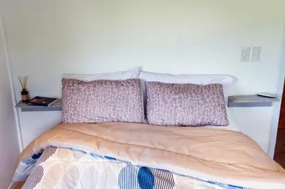 a bed with two pillows on top of it at Las Martinetas in Santa Rosa de Calamuchita