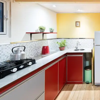 a kitchen with red cabinets and a sink at Las Martinetas in Santa Rosa de Calamuchita