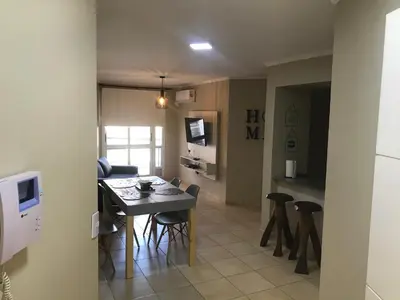 a kitchen and living room with a table and chairs at Elegante Departamento en Alta Córdoba in Cordoba