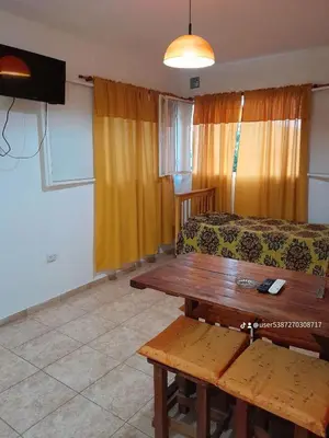 a living room with a couch and a table at Cabaña de Montaña, pileta infinito, wifi, Vista directa al Lago en San Roque a mints de Carlos Paz in Cordoba