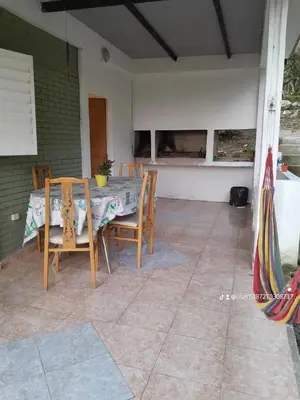a table and chairs sitting on a patio at Cabaña de Montaña, pileta infinito, wifi, Vista directa al Lago en San Roque a mints de Carlos Paz in Cordoba