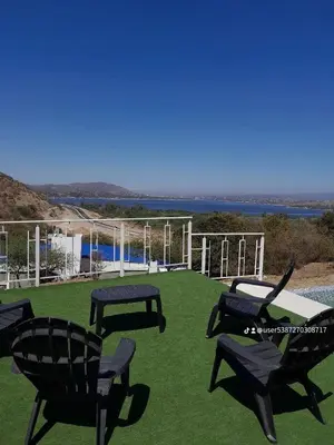 a group of chairs sitting on top of a lawn at Cabaña de Montaña, pileta infinito, wifi, Vista directa al Lago en San Roque a mints de Carlos Paz in Cordoba