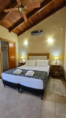 a bedroom with a large bed in a room at La Reina Hotel in Santa Rosa de Calamuchita
