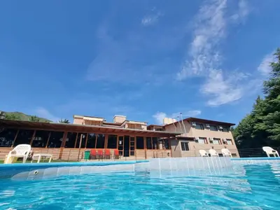 a large swimming pool in front of a building at La Reina Hotel in Santa Rosa de Calamuchita