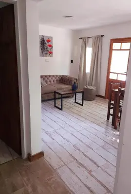 a living room with a couch and a table at Complejo Las Violetas in Merlo
