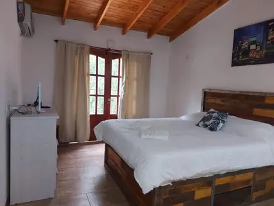 a bedroom with a bed in a room with a window at Complejo Las Violetas in Merlo