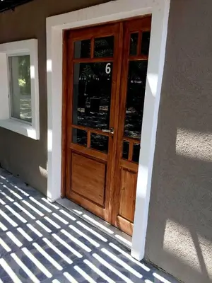 a wooden door of a building with a window at Complejo Las Violetas in Merlo
