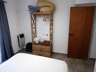 a room with a bed and a room with a door at Departamentos Talamuchita in Santa Rosa de Calamuchita