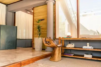 a wooden chair sitting in a room with a desk at Hotel Chapaqñan in Villa Rumipal