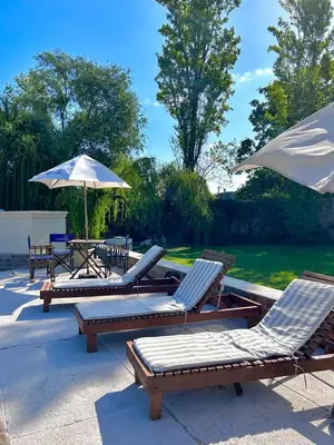 a group of chairs and umbrellas on a patio at Hotel Chapaqñan in Villa Rumipal