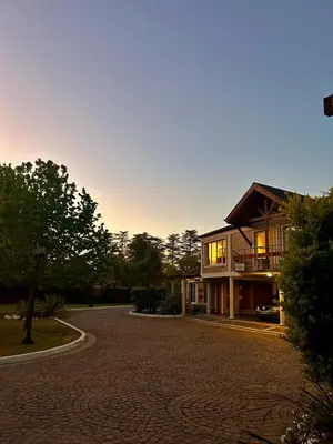a house with a driveway in front of it at Hotel Chapaqñan in Villa Rumipal