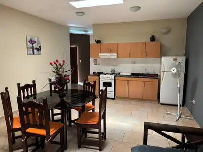 a kitchen and dining room with a table and chairs at La Morena in Villa Carlos Paz