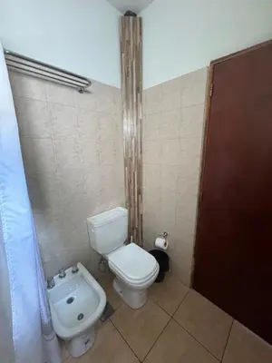 a bathroom with a toilet and a sink at La Morena in Villa Carlos Paz