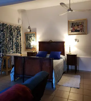 a bedroom with a bed with blue pillows at CERRO LOFT in Cordoba