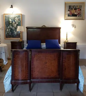 a wooden bed with blue pillows in a room at CERRO LOFT in Cordoba