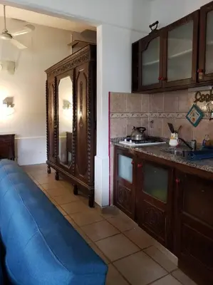 a kitchen with a blue couch next to a sink at CERRO LOFT in Cordoba