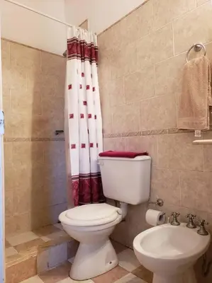 a bathroom with a toilet and a shower curtain at CERRO LOFT in Cordoba