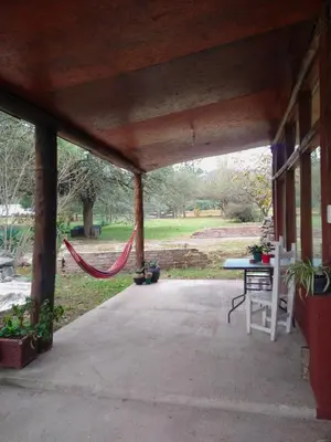 a screened porch with a hammock in the middle at Cabaña en Villa General Belgrano in Villa General Belgrano
