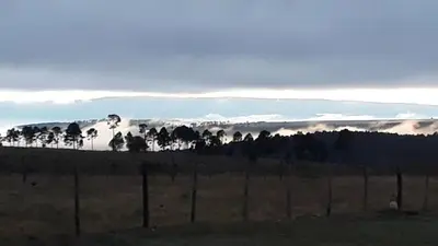 a fence in a field with a mountain in the background at Yacanto360 in Villa Yacanto