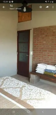 a room with a bench in front of a door at Yacanto360 in Villa Yacanto