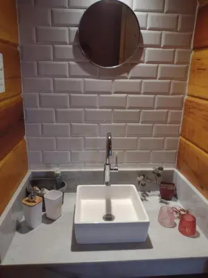 a bathroom sink with a mirror on top of it at Latitud 32 in Villa Yacanto