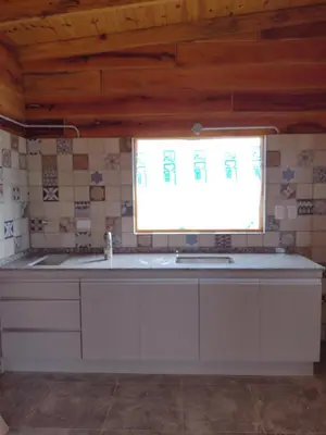 a kitchen with a sink and a window at Latitud 32 in Villa Yacanto