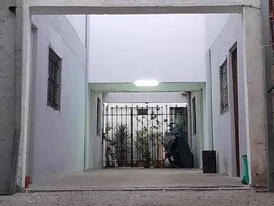 an open doorway to a building with a gate at La Vecindad in Cordoba