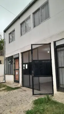 a building with a large glass door in front of it at La Vecindad in Cordoba
