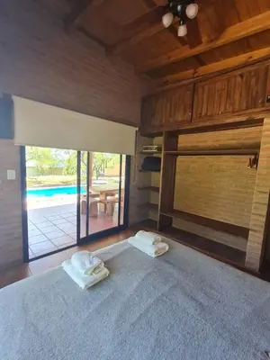 a bedroom with a bed with two towels on it at Cabaña Flor de Lis in San Javier