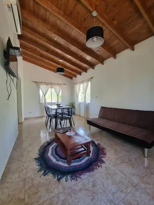 a living room with a couch and a table at Cabañas MIS SUEÑOS in Merlo