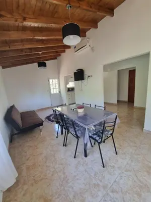 a large dining room with a table and chairs at Cabañas MIS SUEÑOS in Merlo