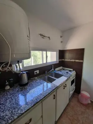 a kitchen with a sink and a counter top at Cabañas MIS SUEÑOS in Merlo