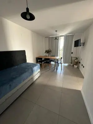 a bedroom with a bed and a dining room table at Em Departamento Amoblado Cordoba in Cordoba