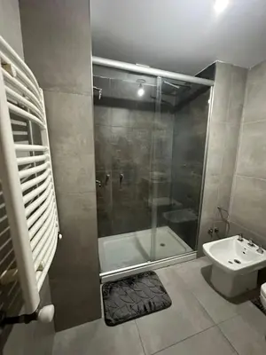 a bathroom with a shower and a toilet and a sink at Em Departamento Amoblado Cordoba in Cordoba