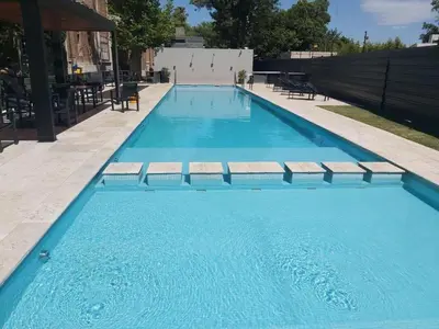 a large swimming pool with blue water at Em Departamento Amoblado Cordoba in Cordoba