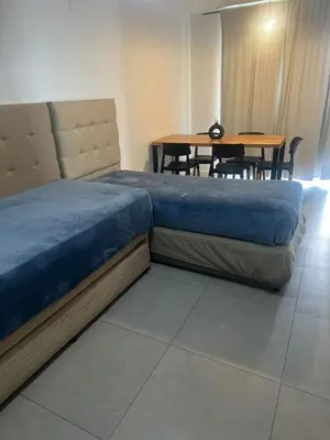 a bedroom with a large bed and a table at Em Departamento Amoblado Cordoba in Cordoba