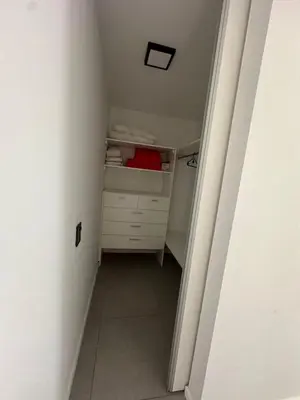 an attic room with a white dresser in a room at Em Departamento Amoblado Cordoba in Cordoba