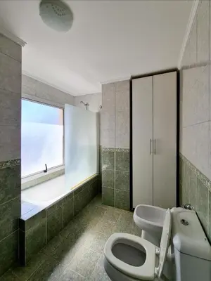 a bathroom with a white toilet and a window at Departamento Nueva Córdoba RW in Cordoba
