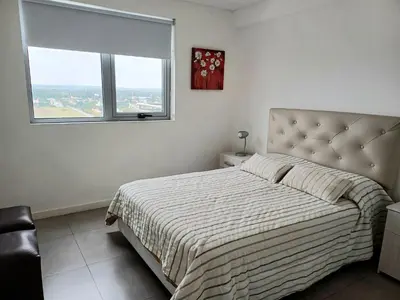 a bedroom with a large bed and a window at Pampa Mora- Estadio Kempes in Cordoba