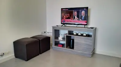 a flat screen tv sitting on top of a entertainment center at Pampa Mora- Estadio Kempes in Cordoba