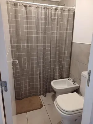 a bathroom with a toilet and a shower at Pampa Mora- Estadio Kempes in Cordoba