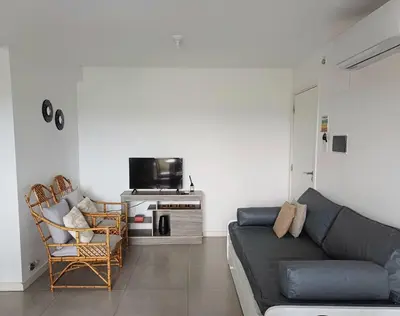 a living room with a couch and a tv at Pampa Mora- Estadio Kempes in Cordoba