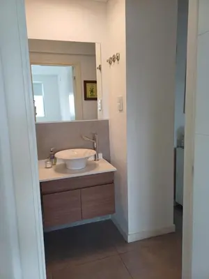 a bathroom with a sink and a mirror at Pampa Mora- Estadio Kempes in Cordoba