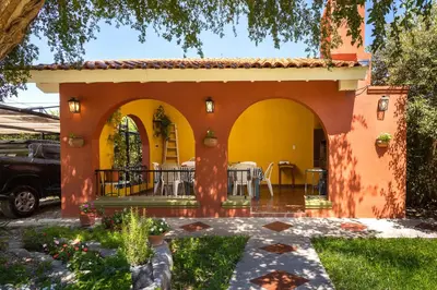 an orange and yellow house with a patio at Complejo Calas in Merlo