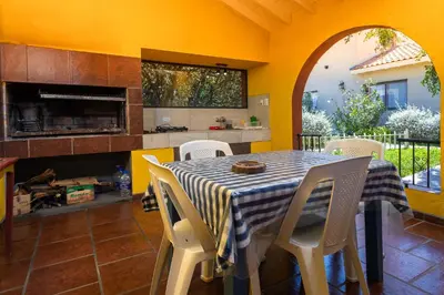 a dining room with a table and chairs and a fireplace at Complejo Calas in Merlo