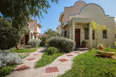 a house with a walkway in front of a yard at Complejo Calas in Merlo