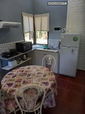 a kitchen with a table and a refrigerator at Complejo Calas in Merlo